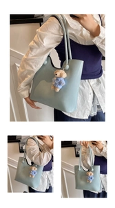 Detail of light blue tote bag featuring a cute teddy bear charm and silver button closure