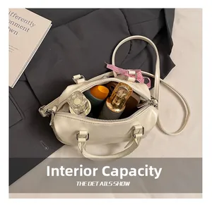 Detail showing the spacious interior of this creamy Boston bag with perfume and cosmetics