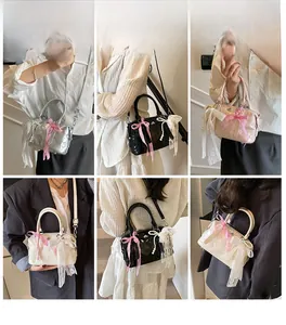 Detail view of stylish pillow bag with bow, lace, and pearls in four trendy colors