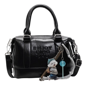 Minimalist black Boston handbag for women with cartoon dog charm and lettering detail