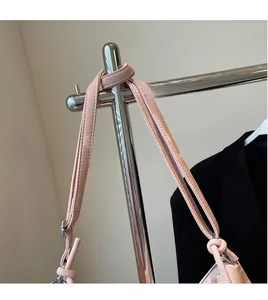 Detail of the smooth pink leather shoulder strap with silver metal buckle on the tote bag