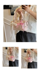 Pink glossy Boston bag featuring lace ribbons pearl chains and textured 3D patterns