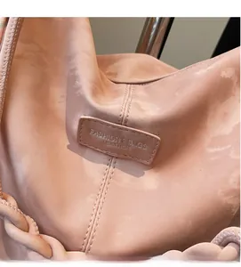 Detail of matte leather texture with double stitching and woven decorative strap