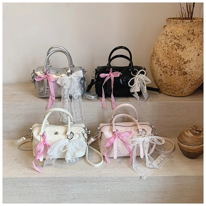Detail of four pillow bags in silver, black, beige, and pink with heart embossing