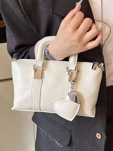 Elegant white PU leather handbag with litchi texture and a heart-shaped charm accessory
