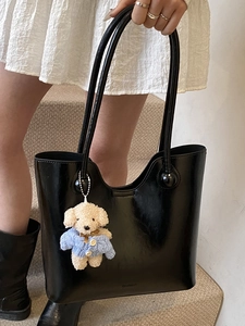 Minimalist black faux leather tote bag with a cute teddy bear charm for women