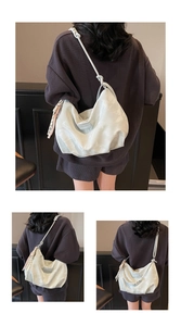 Detail of light beige tote bag with soft pleated texture and unique rope knot shoulder strap