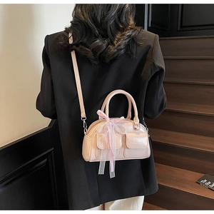 Polished pink Boston bag detail with plaid ribbon bow and chic silver hardware accents