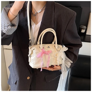 Detail of cream PU leather Boston bag with pink plaid bow and pearl lace ribbon