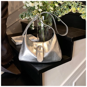 Detail of silver metallic hobo bag with pleated texture and silver pin buckle detail