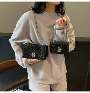 Detailed comparison of large and mini fish scale textured crossbody bags with silver chains