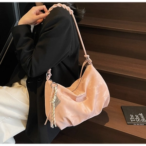 Detail of pink nylon hobo bag with thick woven rope handle and rectangular logo patch