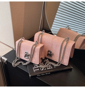 Close-up of pink fish scale textured crossbody bags with silver chain straps