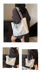 Detail showing white soft leather tote bag with lace bow decoration for women