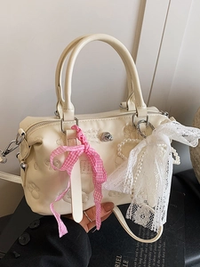 Chic cream Boston bag with embossed animal patterns and cute decorative charms