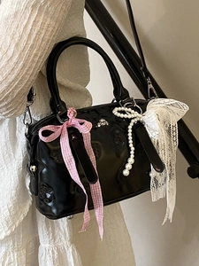 Glossy black patent leather Boston bag with cat claw embossing and pearl ribbon details