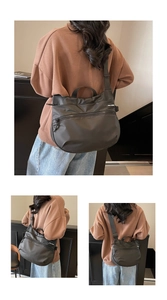 Three-way view of a large black nylon travel tote bag showing adjustable straps and logo