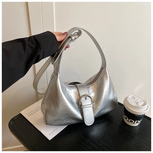 Detail of silver metallic hobo bag featuring moon shape and pleated texture finish