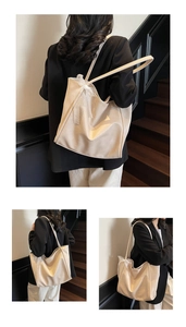 Detail of beige large tote bag with elegant white lace bow and smooth soft leather texture