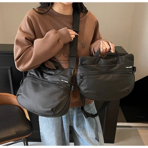 Detail of black nylon tote bags in large crossbody and small handbag sizes for travel
