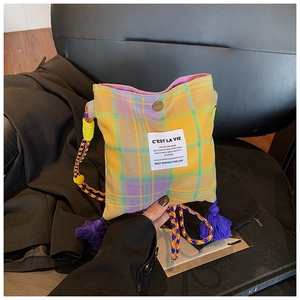 Detail of vintage plaid mini crossbody bag with metal magnetic buckle and colorful strap