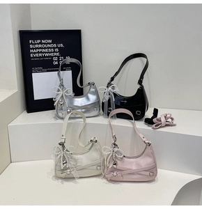 Detail of hobo bags with metallic buckles, pearl charms and lace bows in four colors