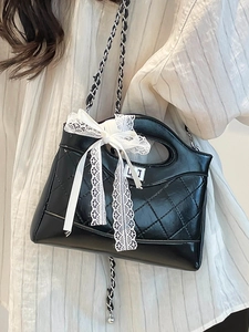 Quilted black bucket bag with white lace bow and silver metal chain strap for women