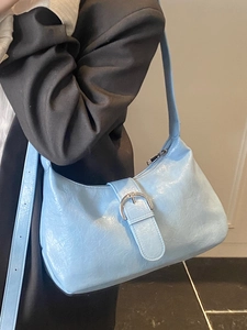 Modern light blue crescent hobo bag in glossy pleated leather with large silver buckle