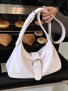 Chic white croissant-shaped hobo bag in textured leather with silver buckle detail