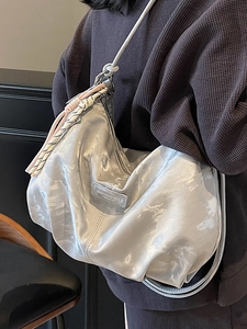 Chic silver metallic hobo bag with woven rope detail and soft cloud-like texture