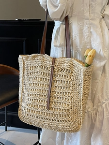 Bohemian large capacity straw tote bag with brown leather straps and metal buckle detail