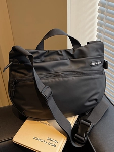 Minimalist black nylon crescent travel tote bag with wide strap for sport and leisure