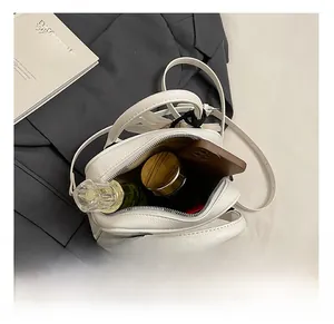 Detail view showing the spacious interior storage of this white litchi leather handbag