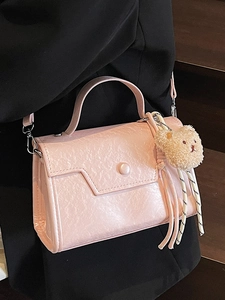 Pink minimalist crossbody bag with pleated texture and cute teddy bear charm for women