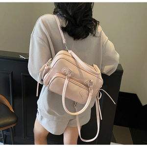 Pink bow boston bag with adjustable straps shown from a high-angle back view lifestyle shot