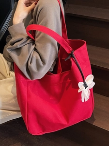 Large red canvas tote bag with floral charm for casual commuting and daily styling