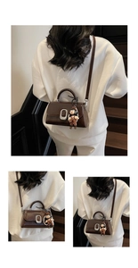 Brown vintage leather handbag with silver buckle and cute cartoon doll pendant accessory