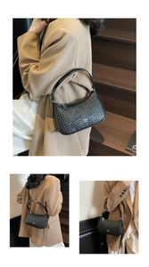 Close-up of black woven leather shoulder bag with zipper and logo for women