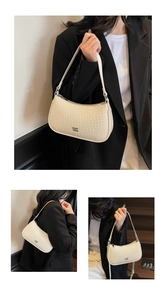 Detail showing white woven crescent shoulder bag with metallic logo and zipper texture
