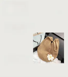 Close-up of khaki woven tote bag showing hollow knit pattern and white floral detail