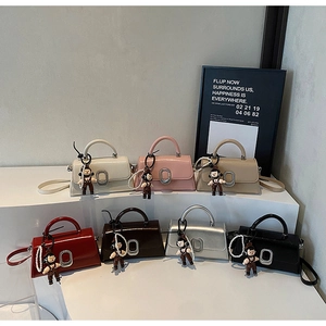 Detailed display of mini handbag collection in seven colors with sleek metal buckles