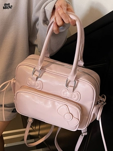 Pink patent leather bow boston bag with glossy finish and versatile straps for women