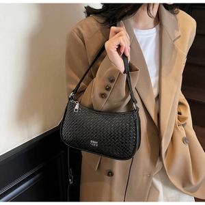Detail of black woven leather shoulder bag featuring silver logo and metallic zipper close-up