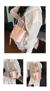 Detail of light pink glossy bucket bag with silk scarf and FASHION & X.M embossed logo