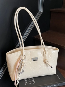 Creamy white tote bag with cute embossed cartoon patterns and dual top handles