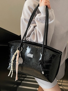 Glossy black underarm bag with embossed bear patterns and a silver tennis charm