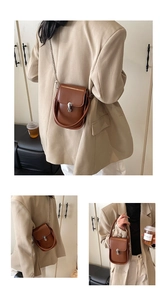 Detailed views of a brown vintage leather handbag with silver chain and metal lock