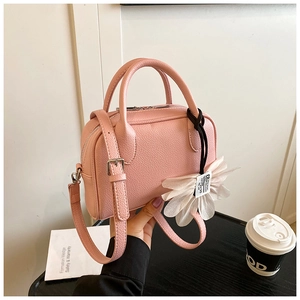 Pink lychee texture Boston bag detail featuring top handles and mesh flower charm