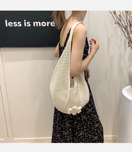 Detailed close-up of ivory crochet tote bag with 3D daisy flower and hollow-out knit pattern