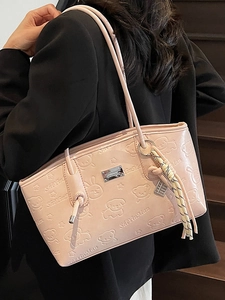 Pink underarm tote bag with embossed cartoon bear patterns and decorative charm